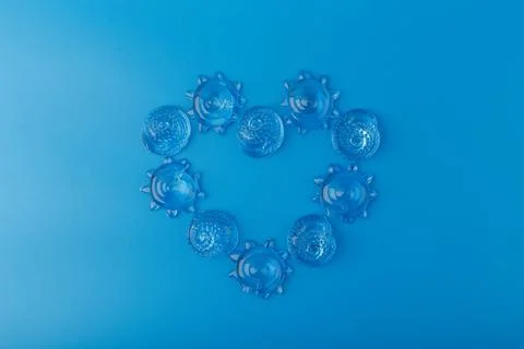 Creative flat lay with heart made of sea shells on blue background. Concept of Stock Photos