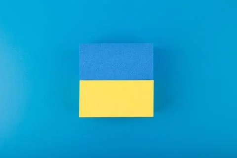 Creative flat lay with national flag of Ukraine on dark blue background Stock Photos