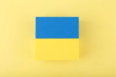 Creative flat lay with national flag of Ukraine on light yellow background Stock Photos
