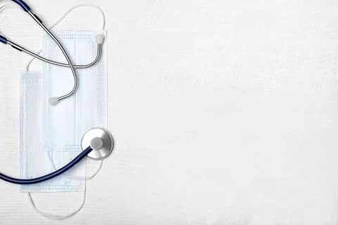 Creative flat lay overhead composition with stethoscope, disposable  face mas Stock Photos