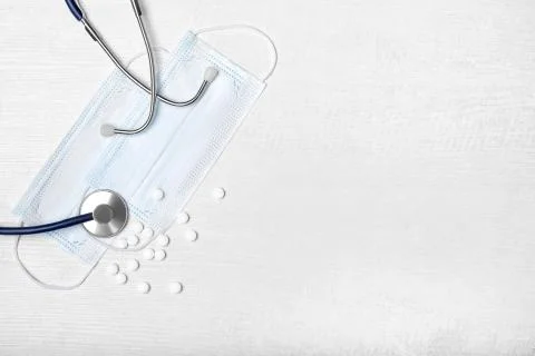 Creative flat lay overhead composition with stethoscope, disposable  face mas Stock Photos