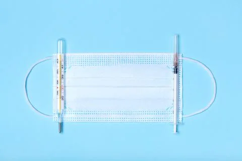 Creative flat lay overhead composition with medical disposable face mask, bod Stock Photos