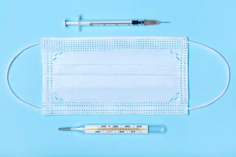 Creative flat lay overhead composition with medical disposable face mask, bod Stock Photos