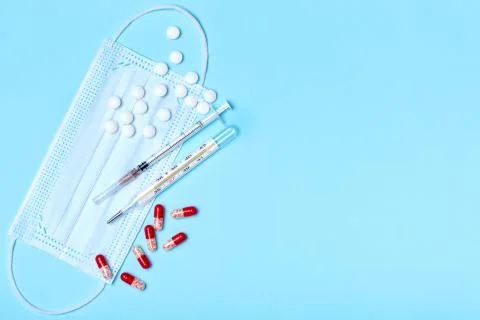 Creative flat lay overhead composition with medical disposable face mask, bod Stock Photos