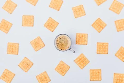 Creative flat lay pattern of salty crackers and cup of coffee 스톡 사진