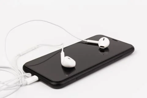 Creative flat lay photo of workspace desk with earphones and mobile phone Stock Photos