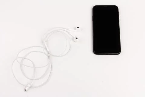 Creative flat lay photo of workspace desk with earphones and mobile phone Stock Photos