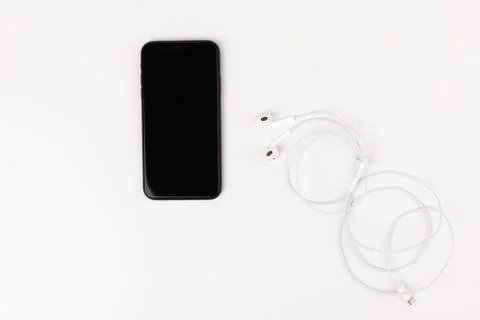 Creative flat lay photo of workspace desk with earphones and mobile phone Stock Photos