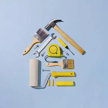 Creative flat lay still life with tools forming a small house Stock Photos