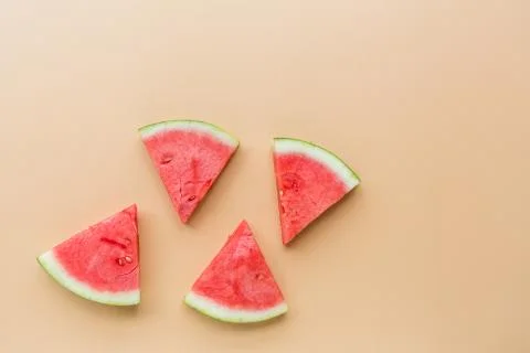 Creative flat lay top view of fresh watermelon slices on orange table backgro Stock Photos