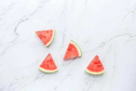 Creative flat lay top view of fresh watermelon slices on white marble backgro Stock Photos