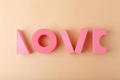 Creative flat lay of word love made of pink geometric figures against light Stock Photos