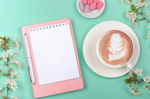 Creative flat lay of workspace desk, notepad and lifestyle objects on green Stock Photos