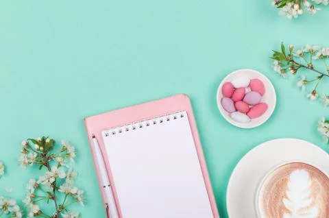 Creative flat lay of workspace desk, notepad and lifestyle objects on green Stock Photos