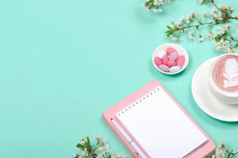 Creative flat lay of workspace desk, notepad and lifestyle objects on green b Stock Photos