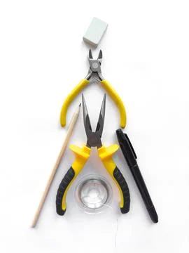 Creative flat lay of yellow hand tools and office supplies on white background Stock Photos