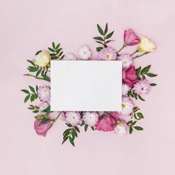Creative floral composition with blank paper in the centre. Stock Photos