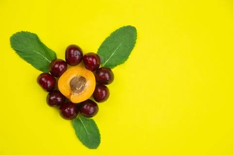A creative flower consisting of half an apricot with a heart stone and petals in Stock Photos