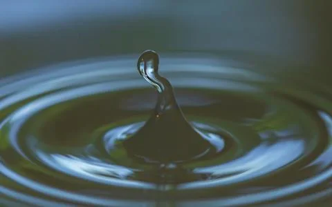 Creative form water drop and splash Stock Photos