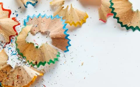 Creative frame made of color pencil shavings a on a white paper. Stock Photos