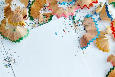 Creative frame made of color pencil shavings a on a white paper. Stock Photos