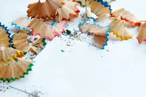 Creative frame made of color pencil shavings a on a white paper. Stock Photos