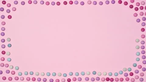 Creative frame pastel pink background with rainbow candies. Stop motion flat lay Stock-Footage 170333097