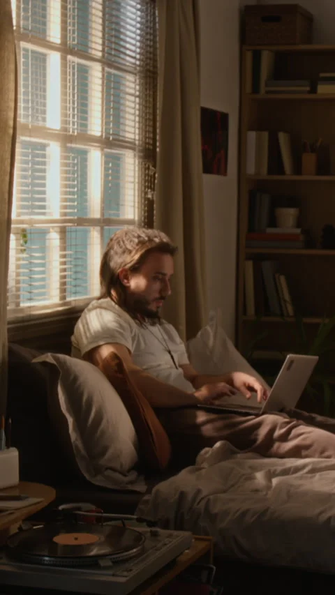 Creative Freelancer Man Working on Laptop in Bed at Home Stock Footage 337543483