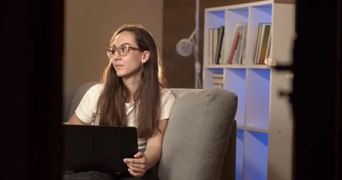 Creative freelancer works in the evening in the room. View from another room Video stock 132445178