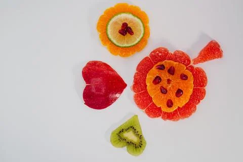 Creative fruit composition symbolizing love and health on white background Stock Photos
