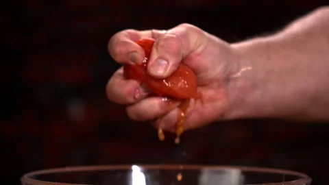 Creative Fun Shot of Hand Squishing Tomato Stock Footage 130400153