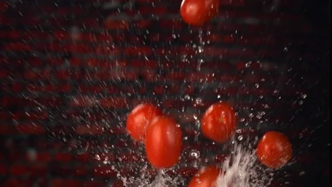 Creative Fun Shot of Tomatoes Dropping Into Water in Slow Motion Stock Footage 130399300