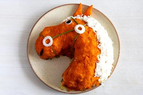 Creative funny layer salad in red horse head shape. Chinese new year or children Stock Photos