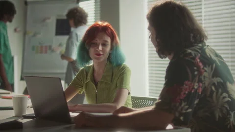 Creative Gen Z Colleagues Discussing Data on Laptop at Office Table Stock Footage 340486953