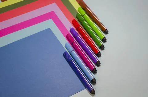 Creative geometric composition with colorful felt-tip pens and colored paper. Stock Photos