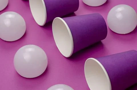 Creative geometric composition with paper cups and white spheres on a pink ba Stock Photos