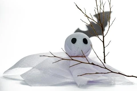 Creative Ghost Decoration Made of White Fabric With Twigs on a Plain Backgr.. Stock Photos