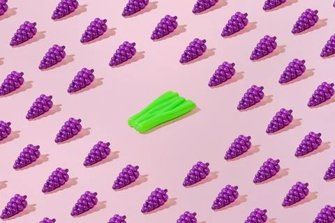 Creative grape and leek pattern flat lay pastel pink background minimalism Stock Photos