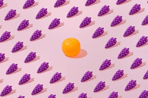 Creative grape and orange pattern flat lay pastel pink background minimalism Stock Photos