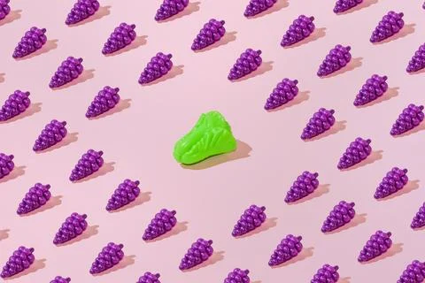 Creative grape and salad pattern flat lay pastel pink background minimalism Stock Photos