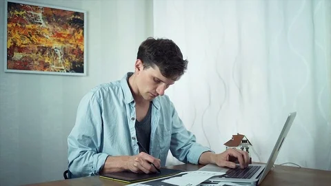 Creative graphic designer sketching on tablet housing project. Stock Footage 79902441