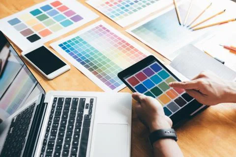 Creative graphic designer using graphics tablet to choosing color swatch samp Stock Photos