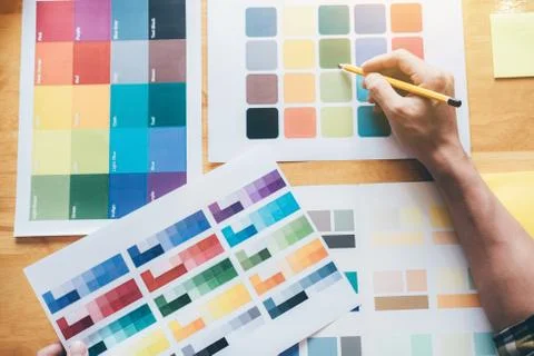 Creative graphic designer using graphics tablet to choosing color swatch samp Stock Photos