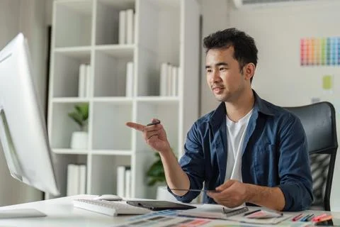 Creative Graphic Designer Working in Modern Design Studio with Digital Tools and Stock Photos