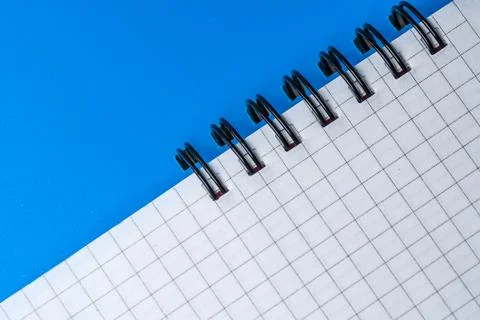 Creative grid notebook rests on a bright blue background Stock Photos