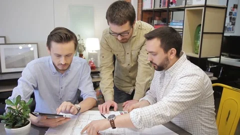 Creative group on building project discussing issues inside office Video stock 77451646