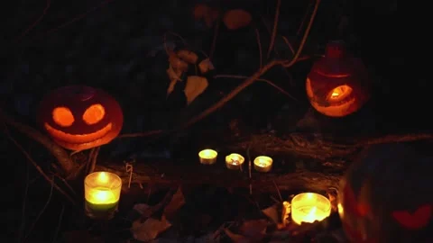 Creative Halloween composition of glowing carved pumpkins and burning candles Stock Footage 139201787