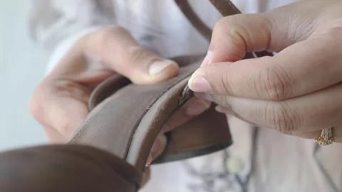 Creative hand stitching for leather sandals repair work Stock Footage 339122973