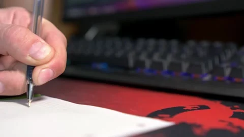 Creative Hand Writing on Paper with Dynamic Keyboard Lighting 動画素材 332600539