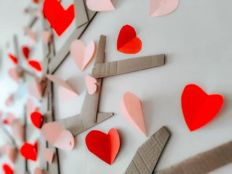 A creative handmade tree made of cardboard branches is decorated with red Stock Photos